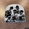 Detailed close-up of light blue beanie featuring black knit skeleton bone patterns - M / Blue