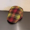 Detail view of the red and yellow plaid pattern on a vintage wool newsboy cap for women - M (55-59cm) / Red and Yellow Plaid