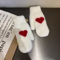 Close-up of white plush mittens with a red heart pattern and soft faux mink texture - One Size / White
