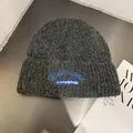 Detail view of dark grey knitted beanie with blue embroidery and chunky texture finish - M (55-59cm) / Dark Gray