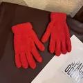 Detailed close-up of red coral fleece winter gloves with fluffy texture and ribbed wrist cuffs - Adult / Red