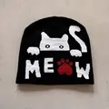 Detail of knitted cat pattern and MEOW text with red paw print on black beanie - M (52-59) / Black
