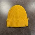 Detailed view of ginger yellow distressed knit beanie with frayed edges and torn design - M (54-59cm) / Yellow