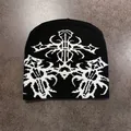 Close-up of black beanie with white ethnic jacquard pattern and gothic totem knitting - Black & White