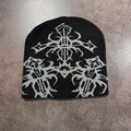 Close-up of gothic jacquard pattern on a black knitted beanie with silver-grey tribal motifs - Black and Gray