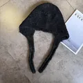 Flat lay of a thick black fleece Balaclava hat with ties on a marble surface - M (55-59cm) / Black