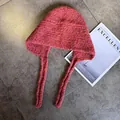 Detailed texture of thick knit balaclava hat with ear flaps and woven wool patterns - M (55-59cm) / Caramel color