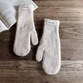 Close-up of beige knit mittens with fuzzy mohair texture and Fashion fabric label - One Size / Beige