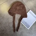 Detailed view of dark brown knitted balaclava with long straps and warm textured fleece - M (55-59cm) / Coffee