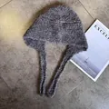 Detail view of a thick grey knitted Balaclava hat with earflaps and tie strings - M (55-59cm) / Dark Purple