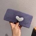 Close-up of a wide purple knitted headband featuring a white heart pattern and soft texture - Purple