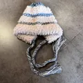 Detail of plush knitted trapper hat with blue stripes and decorative hanging tassels - M (55-59cm) / Beige