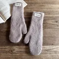 Detail of soft fuzzy knit mittens in dusty purple with white fashion label on wood - One Size / Khaki
