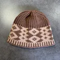 Close-up of vintage geometric jacquard knit pattern and ribbed texture on beanie - Khaki