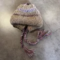 Detailed top view of a fuzzy earflap hat featuring colorful braided tassels and geometric patterns - M (55-59cm) / Khaki