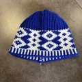 Detailed close-up of blue and white geometric knit pattern on a warm winter beanie hat - Royal Blue