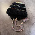 Detail of black plush knit trapper hat with colorful stripes and long braided tassels - M (55-59cm) / Black