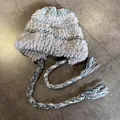 Detail view of plush knitted earflap hat with colorful faux fur and tassels - M (55-59cm) / Gray