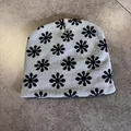 Detailed knit texture of light grey beanie with black floral jacquard pattern - Gray