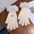Detail of cream knit gloves with faux fur trim and touch screen finger openings - White