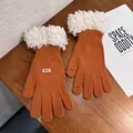 Detail of orange knitted gloves with fur cuffs and touchscreen finger openings - Orange