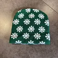 Close-up of green jacquard beanie showing white floral knit texture and warm material - Green