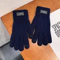 Detail view of navy blue knitted gloves with touch screen fingertips and classic label - Navy Blue