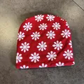Detailed knit texture of a red and white floral patterned beanie for winter warmth - Red