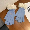 Detail of light blue knit gloves with white faux fur trim and touchscreen fingertips - Blue