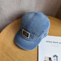 Detail of blue denim 5-panel camper hat with brown leather patch and metal ring - Adjustable / Medium Blue