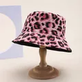 Pink leopard print reversible bucket hat shown on a wooden stand in a clean studio setting - M (55-58cm) / Pink