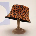 Detailed view of the leopard print bucket hat on a wooden stand with a black interior - M (55-58cm) / Brown