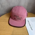 Detail of pink cotton canvas camp hat featuring green West Coast Skating embroidery - Dusty Pink