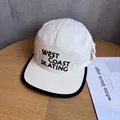 Macro detail of canvas 5-panel camper hat with West Coast Skating embroidery - Beige
