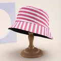 Detail of pink and white striped bucket hat with cotton texture on a wooden stand - Rose Red