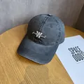 Detailed macro view of embroidered letter W on vintage washed charcoal baseball cap - Adjustable / Dark Gray