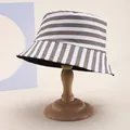Close-up of striped bucket hat featuring coffee and white cotton canvas fabric texture - Coffee