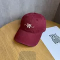 Close-up of white letter embroidery on burgundy cotton twill baseball cap with curved brim - Adjustable / Burgundy