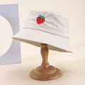 Off-white cotton bucket hat with strawberry embroidery on a vintage wooden hat stand - M (55-58cm) / Beige