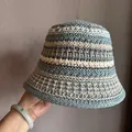 Detailed close-up of hollow crochet texture and stripe pattern on a summer bucket hat - M / Blue