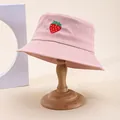 Detailed view of pink bucket hat with strawberry embroidery on high-quality canvas fabric - Pink