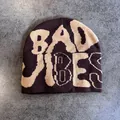 Detailed close-up of dark brown knit beanie featuring beige jacquard Bad Vibes lettering - M (52-59) / Coffee and Beige Letters