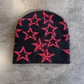 Detail shot of black knitted beanie with red outline star pattern jacquard texture - M / Black With Red Stars