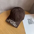 Detailed close-up of vintage brown washed cotton cap with MAOTIME 3D embroidery and distressed brim - Adjustable / Coffee