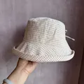 Detail view of beige plaid bucket hat fabric and brown checked pattern with back tie - M (56-59cm) / Beige