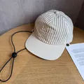 Detail of khaki striped baseball cap featuring white embroidery and adjustable windproof cord - Adult (55-60cm) / Striped Khaki