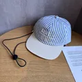 Detail of blue and white striped baseball cap with LEVEIN embroidery and adjustable drawcord - Adult (55-60cm) / Blue Striped