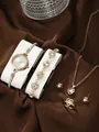 Detailed macro shot of rose gold heart jewelry set and elegant quartz watch on satin - Heart Rhinestone Watch Necklace Bracelet Ring Earrings / Light Gold White