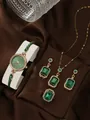 Elegant rose gold women watch and jewelry set with emerald gemstones on silk background - Square Watch Necklace Ring Earrings / Green