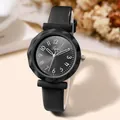 Detail of black quartz watch featuring faceted glass and leather strap on a beige table - Black